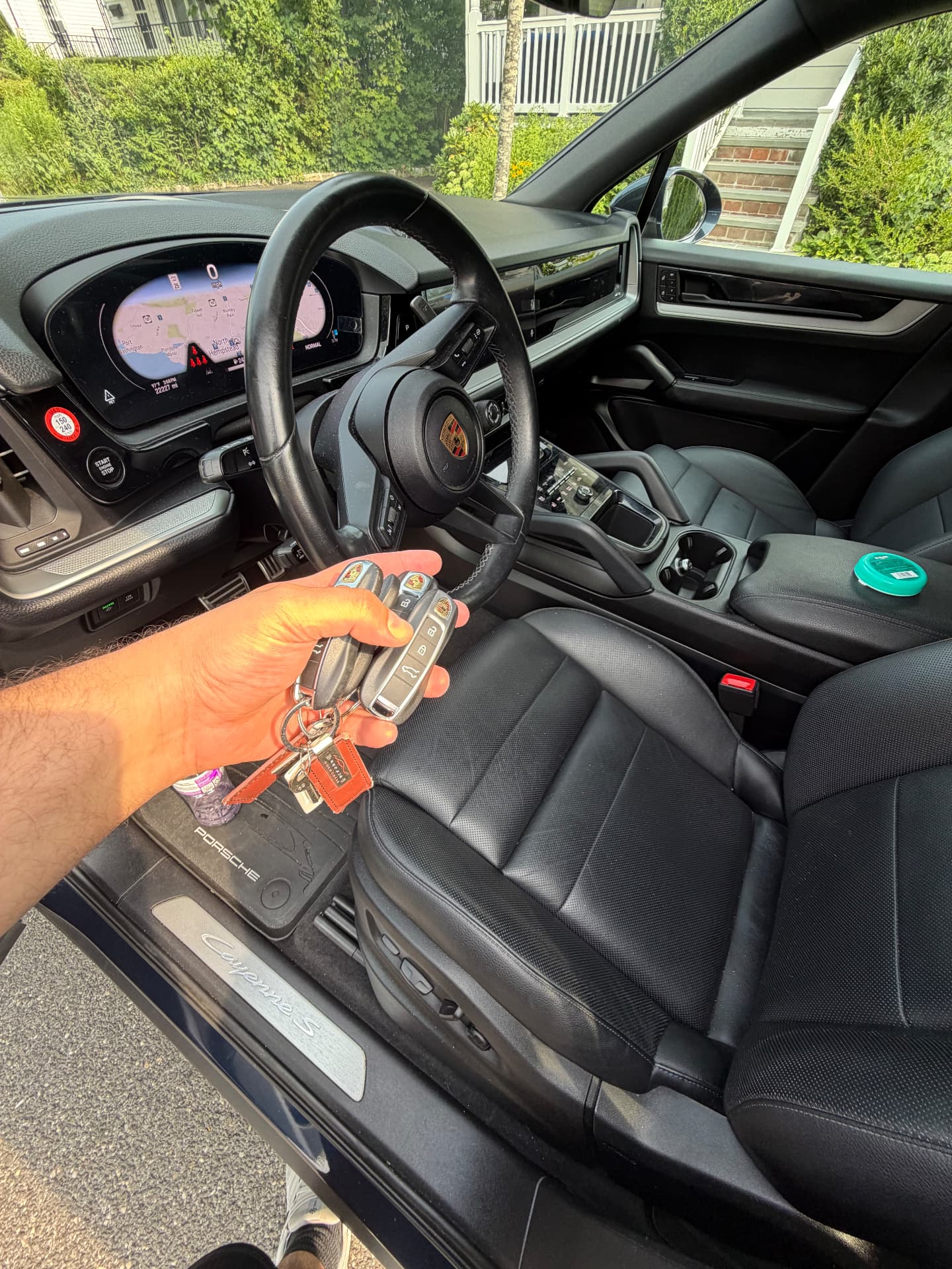 Two programmed Porsche Cayenne smart keys held beside the driver's seat